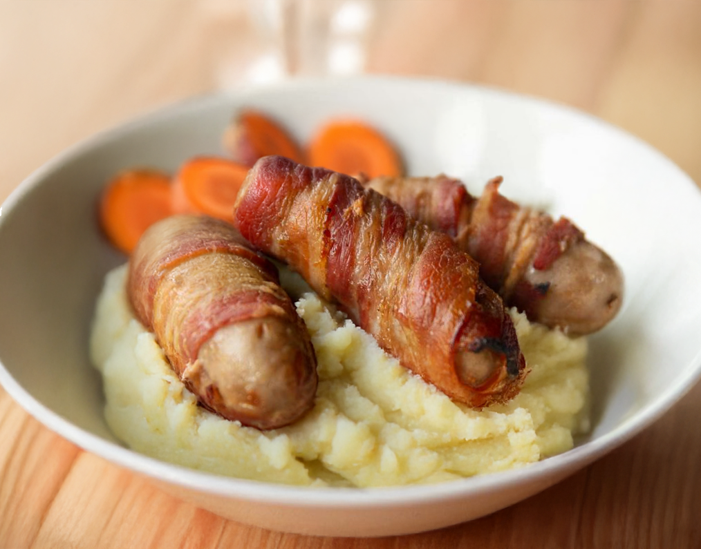 Bacon wrapped Pork Bangers with Cumin Carrot & Sweet Potato Mash